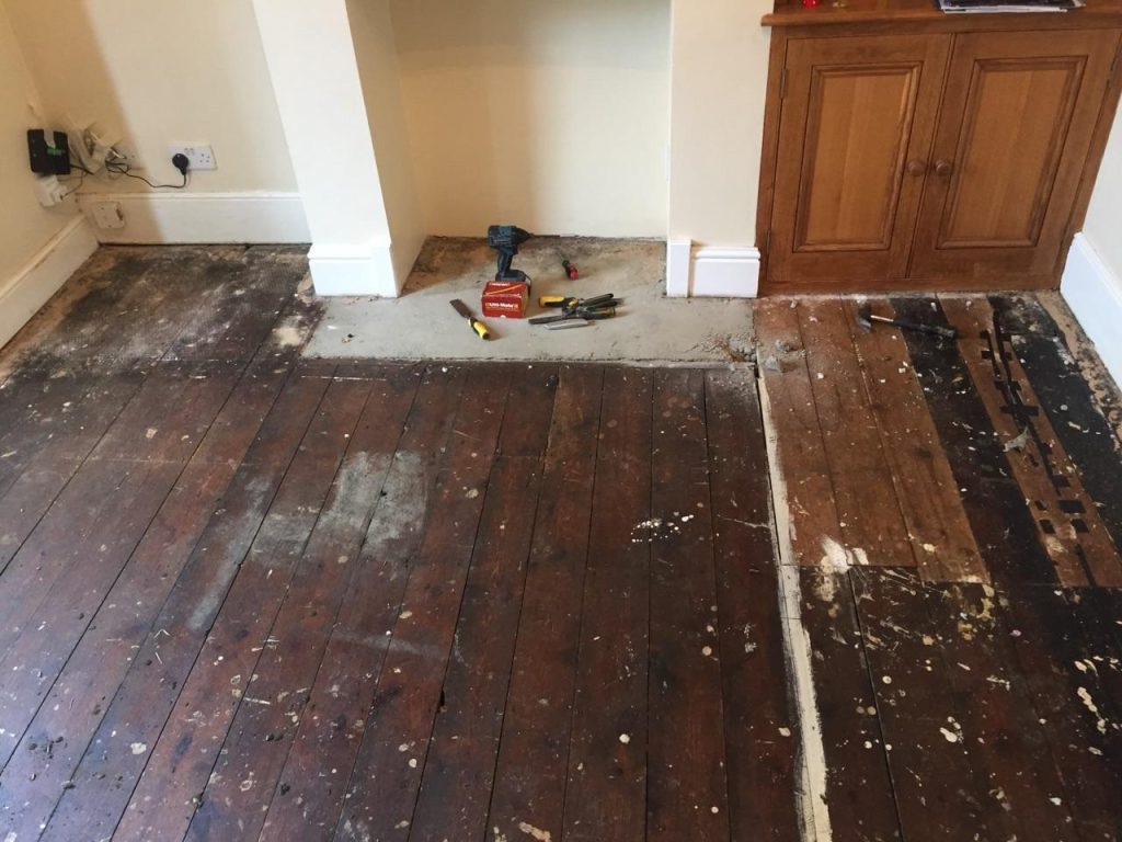 Highly damaged wooden floor at the beginning of repairs